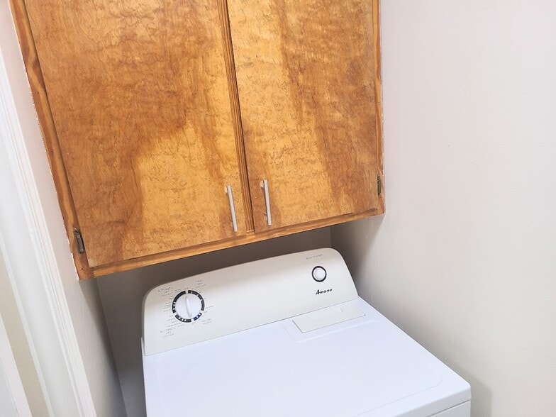 Laundry room with included dryer and more storage - 12439 Coursey Blvd