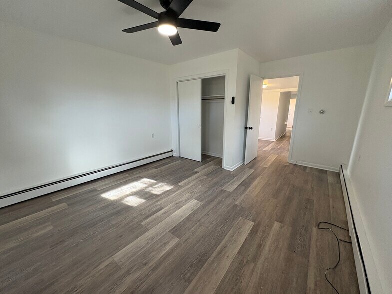 Spacious and bright bedroom with plenty of closet space and ceiling fan - 318 N 4th St