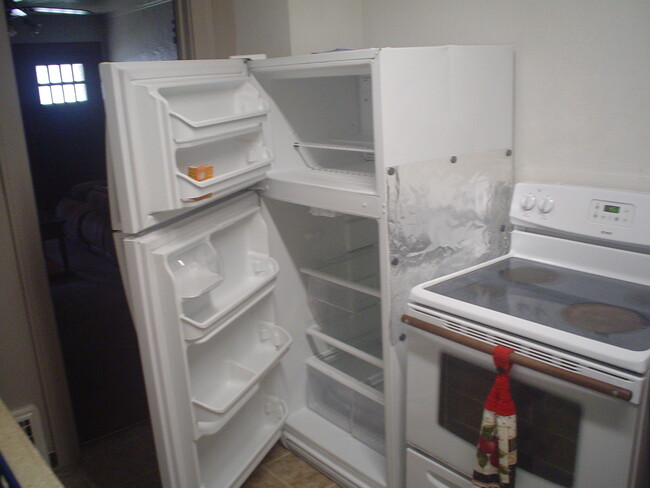 Full size refrigerator and electric stove. - 714 Main St