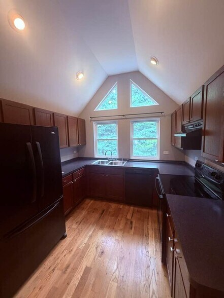 Plenty of kitchen cabinets and plenty of natural light with all the windows. - 5107 Timber Ln