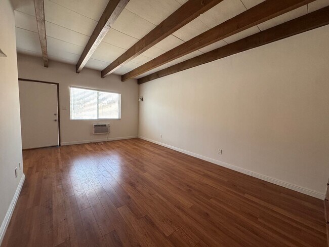 Building Photo - Large and Bright Studio with wood ceiling beams and floors...