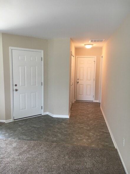 Entry-showing Front Door, Door to Attached Garage, Laundry Room Door to right and Hall Closet to left. - 8590 Jackson St
