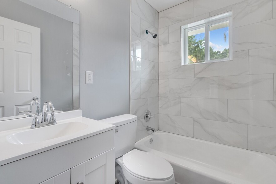 Newly renovated bathroom w/ floor-to-ceiling tiles - 2058 Nettie Ct