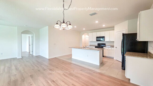 Building Photo - MOVE IN READY ! 4 BEDROOM/2 BATH! TILE- LVP THROUGHOUT! LAWN MOWING INCLUDED!