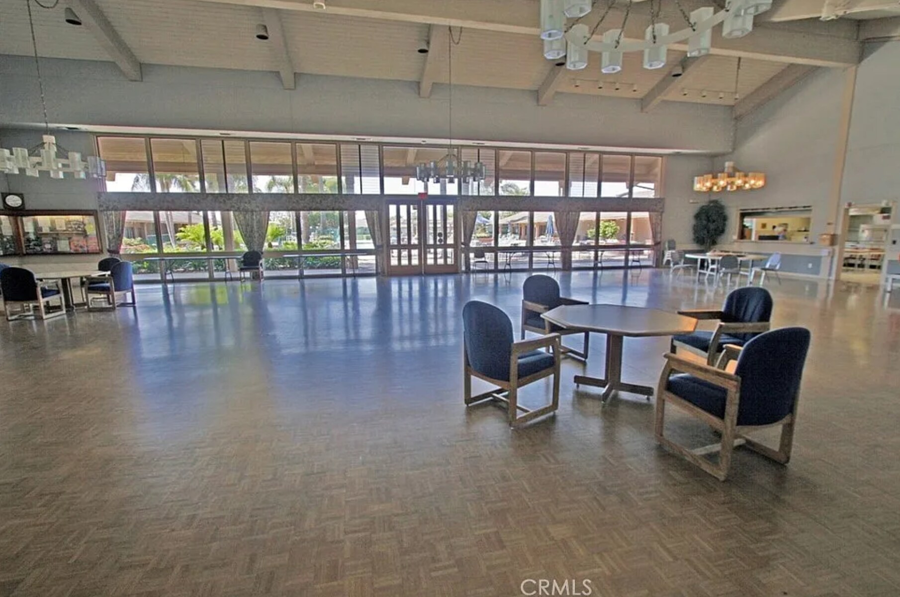 Inside the community center. Wall of windows looks out on the main pool and deck. - 8566 Larkhall Cir