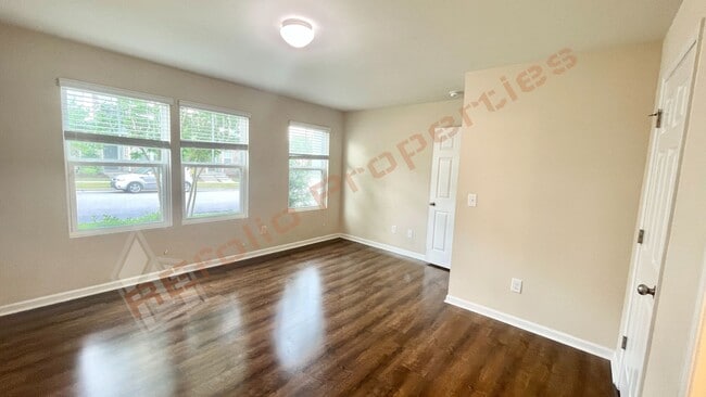 Building Photo - 3 Story Townhome 3 Bedrooms Rear Entry 2 Car Attached Garage with 1st Floor Bedroom, Community Po...