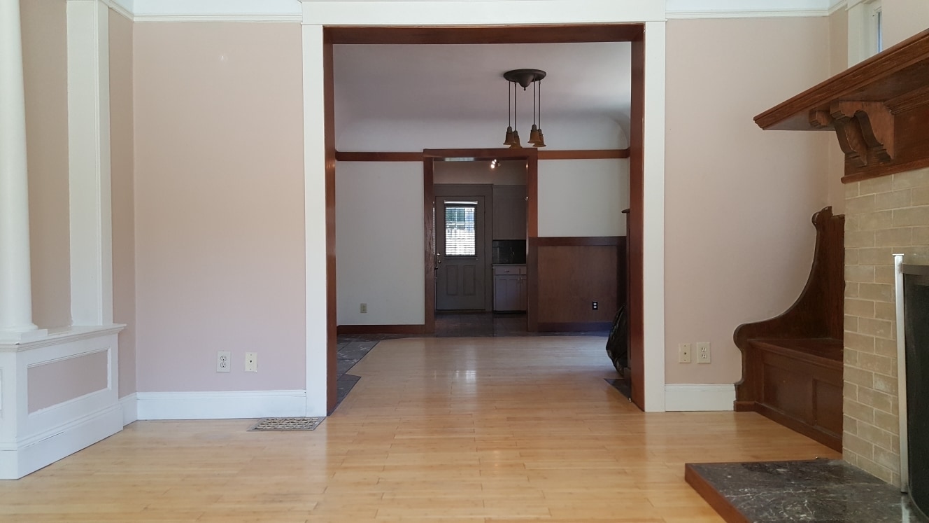 Living area facing kitchen. High vaulted ans moved ceilings. - 1867 SW 14th Ave