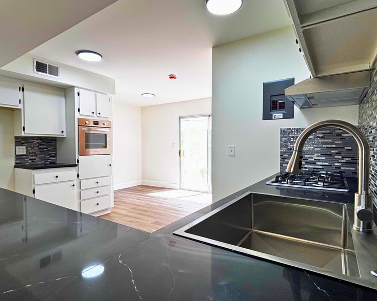 Kitchen, Oven, Fridge Area & Door to Back Patio - 1002 Mission Dr