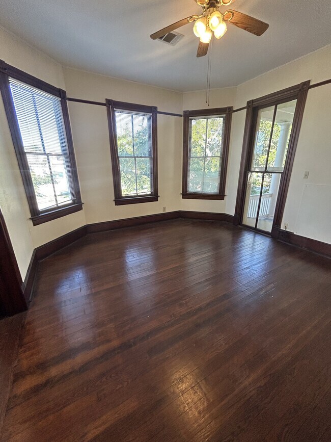 Formal dining room has a bay window and a window leading to an upstairs side porch. - 1118 25th St