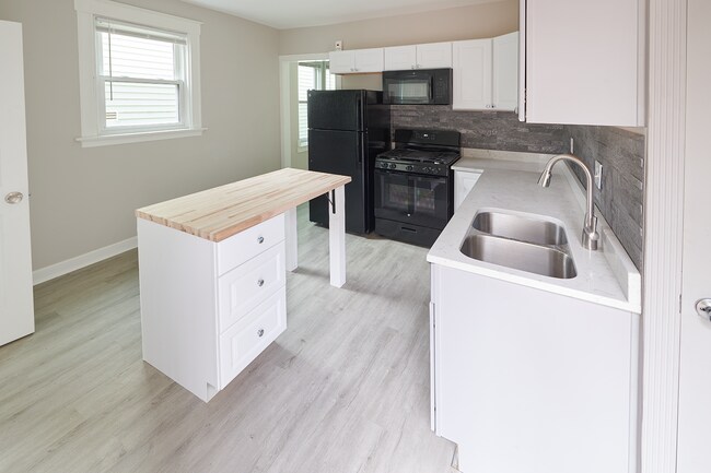Plenty of storage for kitchen utensils, pots, pans and lazy-suzan floor cabinet for food storage - 2354 Victor St