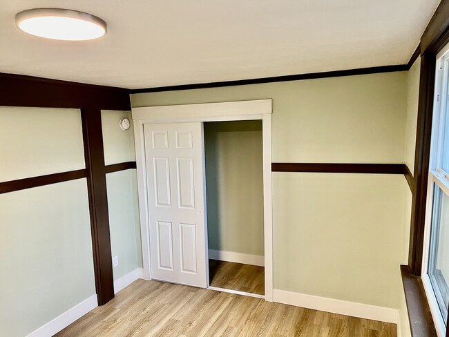 Bedroom closet (slides closed) and home’s exposed support beam. - 1401 W 13th Ave