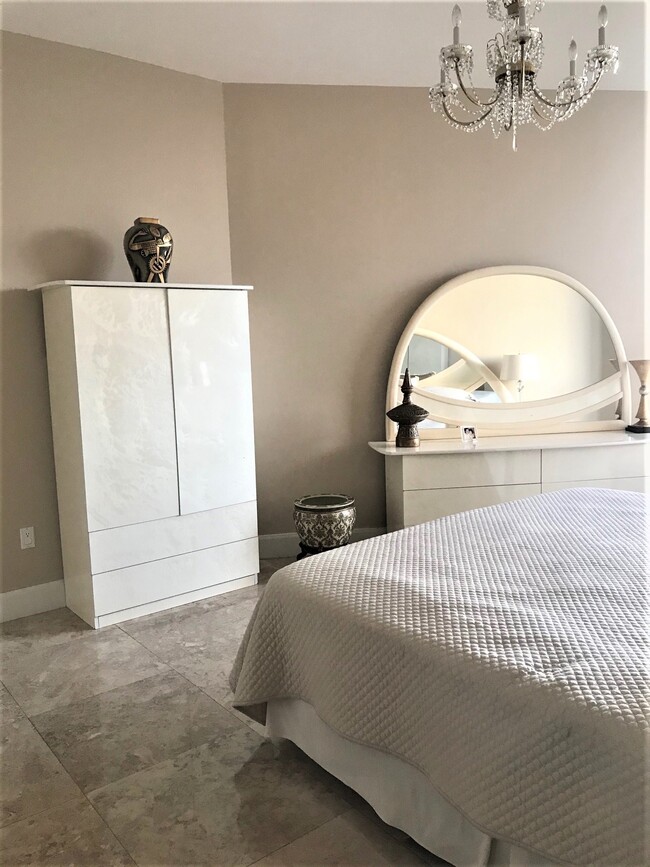 Master Bedroom with king size bed and crystal chandeliers. - 15901 Collins Ave