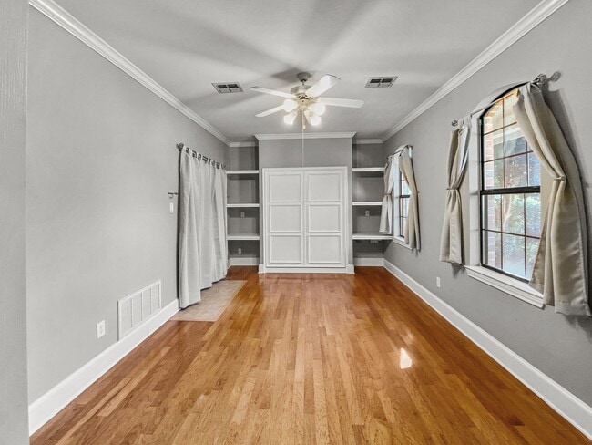 Bedroom/office with built in bookshelves and murphy bed. - 1314 Creekwood Dr