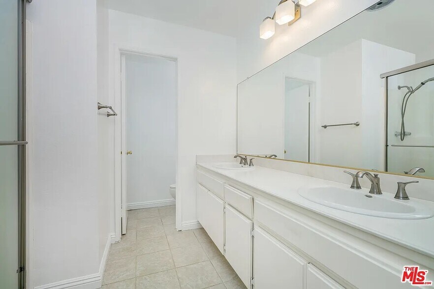 Him and hers vanity in large master bath - 5955 W 8th St
