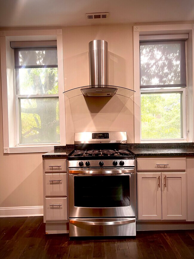 beautiful 5 burner-fire burning, stove/oven with ample natural light - 1926 Fleet St
