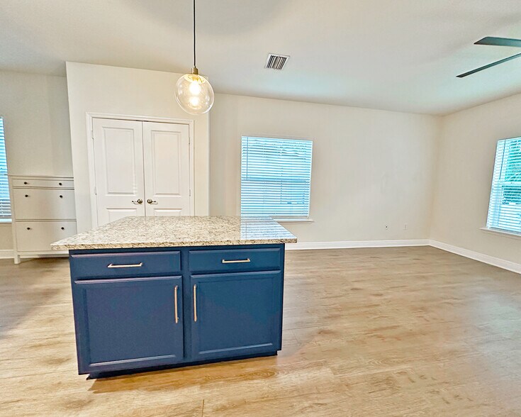 Additional angle of living space featuring large kitchen pantry. - 1736 W Walnut St