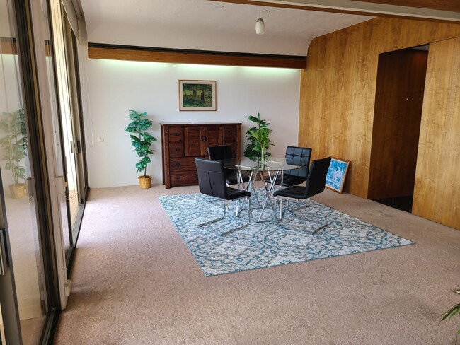 Living room with door leading to Commercial Grade Kitchen - 500 University Ave