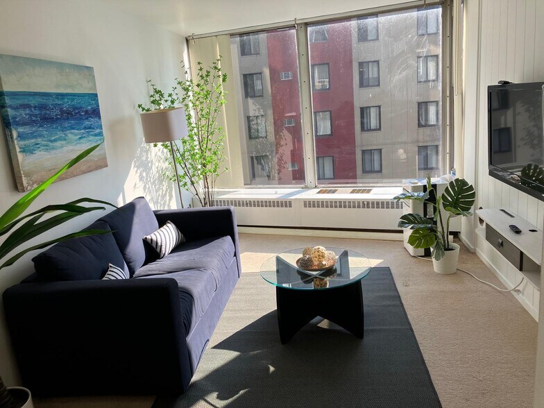 Comfy living room with sofa, TV and an amazing river view - 8200 E Jefferson Ave