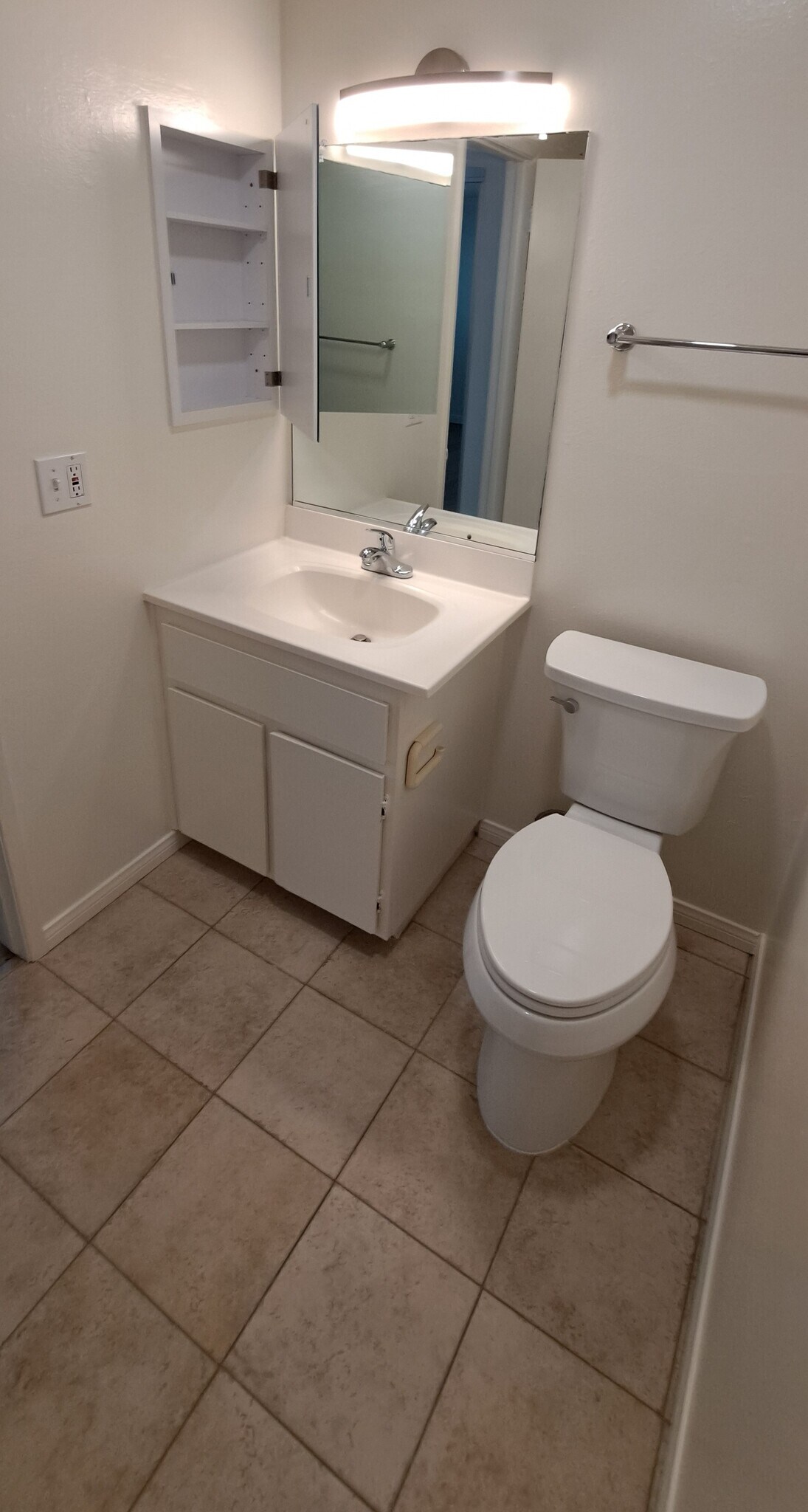 Master Bathroom with new toilet, new medicine cabinet, and new vanity faucet. Porcelain tile floors - 314 20th St