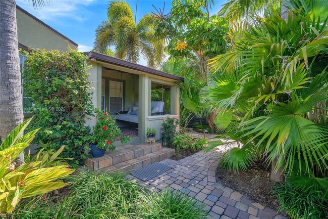 Lushly landscaped paver entry way & delightful front porch with loveseat swing beckon you to this be - 1109 NE 3rd St