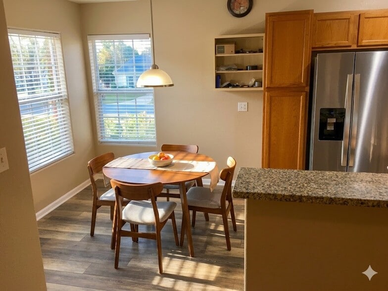 Nice dining space right off the kitchen with lots of sunlight from the adjacent windows. - 8427 Thunder Ridge Way #203