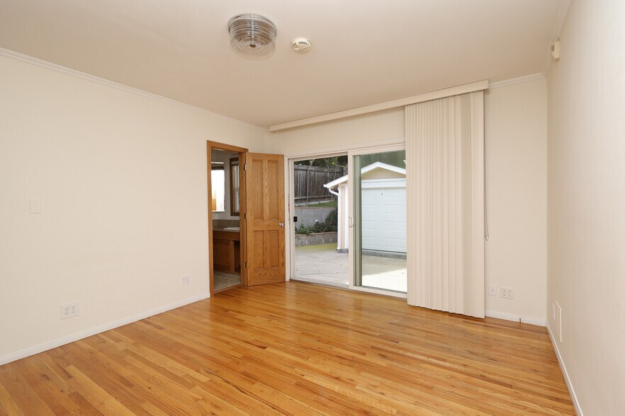 Master bedroom with non-spa second bathroom and sliding door that opens to the back patio - 4831 Canoga Ave