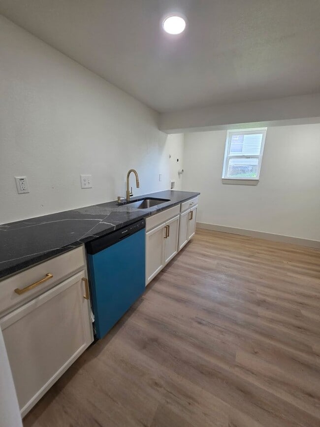 Building Photo - Studio Apartment with bathroom, kitchen & utility area on the lower level of property.