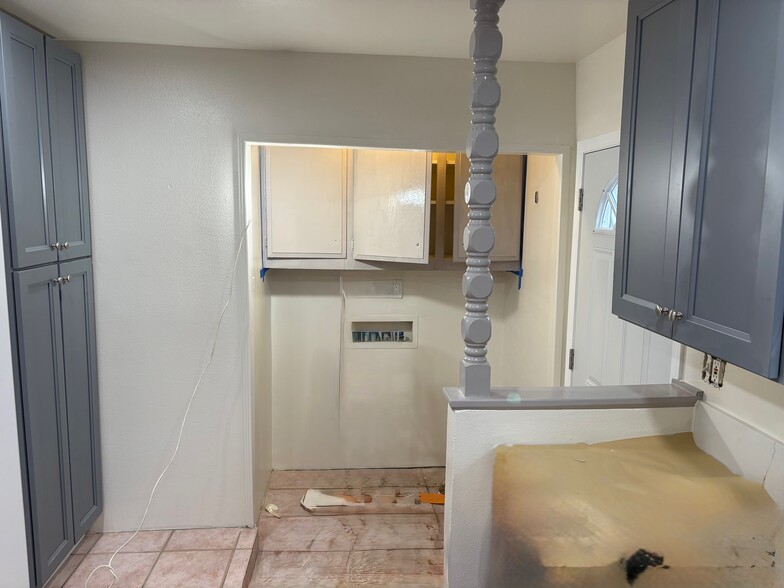 Walking forward toward the washer/dryer hook up area and the back door on the right - 23162 Smith Rd