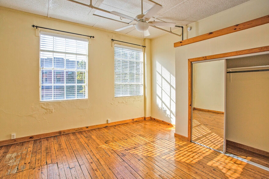 Further down the hallway is the bedroom area with a walk-in closet. Windows face N Hamilton St. - 225 Depot St