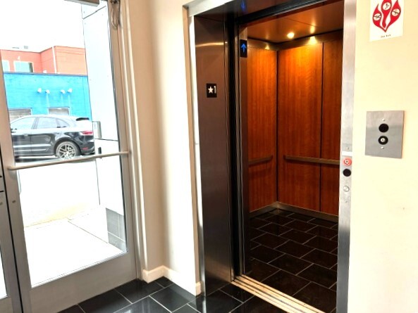 Elevator is finished with tiled flooring and wood paneling - 271 Millburn Ave