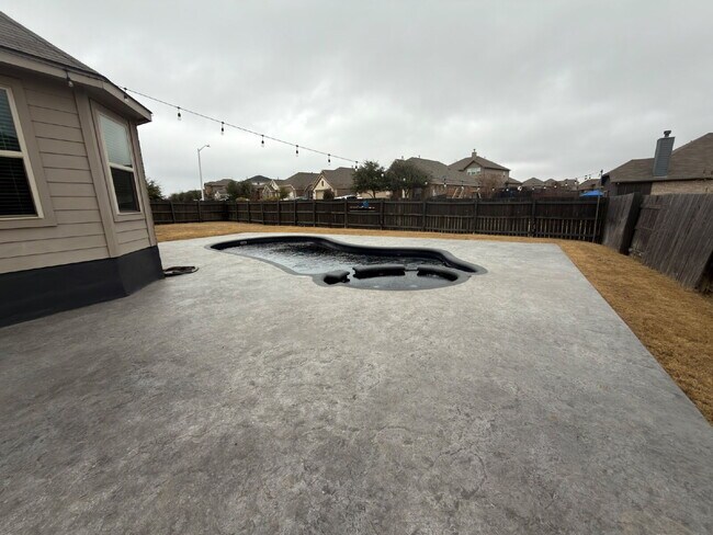 Building Photo - Four bed two bath on a corner lot with a pool in Sunfield. Gas cook top, double ovens. Open kitch...