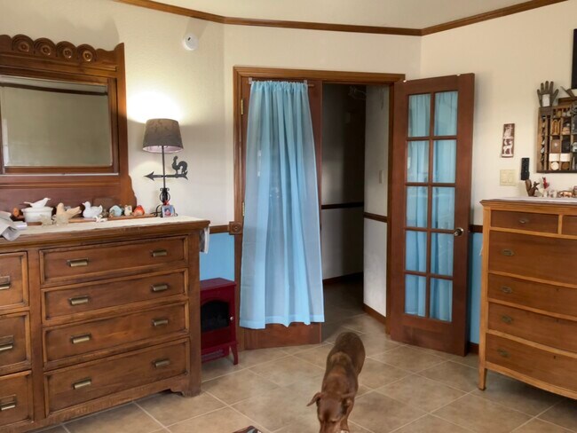 Primary bedroom, French doors lead to kitchen - 308 Hawthorne Dr