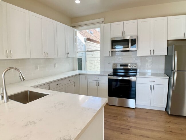 Building Photo - REMODELED 4BR/3BA. In Unit Laundry! Dishwasher! Bay Windows!