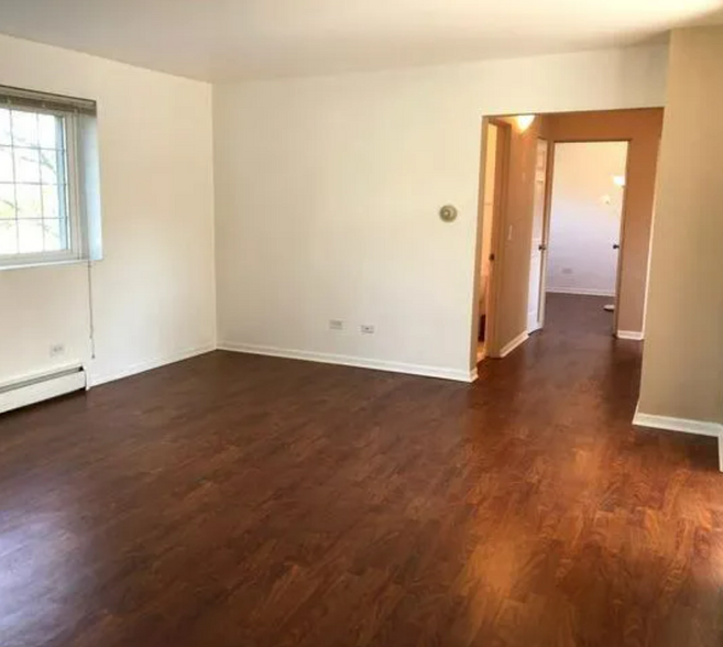 View of hallway leading to bath and 3 bedrooms. - 417 W Miner St