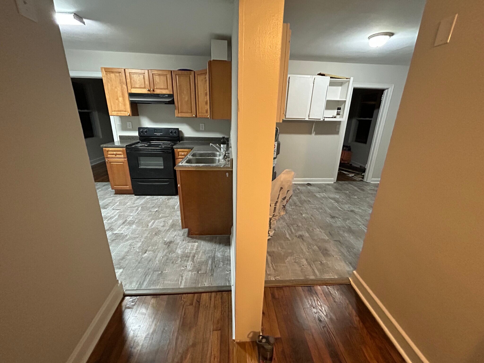 Brand new flooring. Left side is kitchen right is laundry room with entry door and leads to bedroom - 305 Orange St