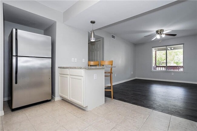 Building Photo - Stunning Renovation - New Hardwood flooring, tile in Kitchen. Granite countertops, breakfast bar