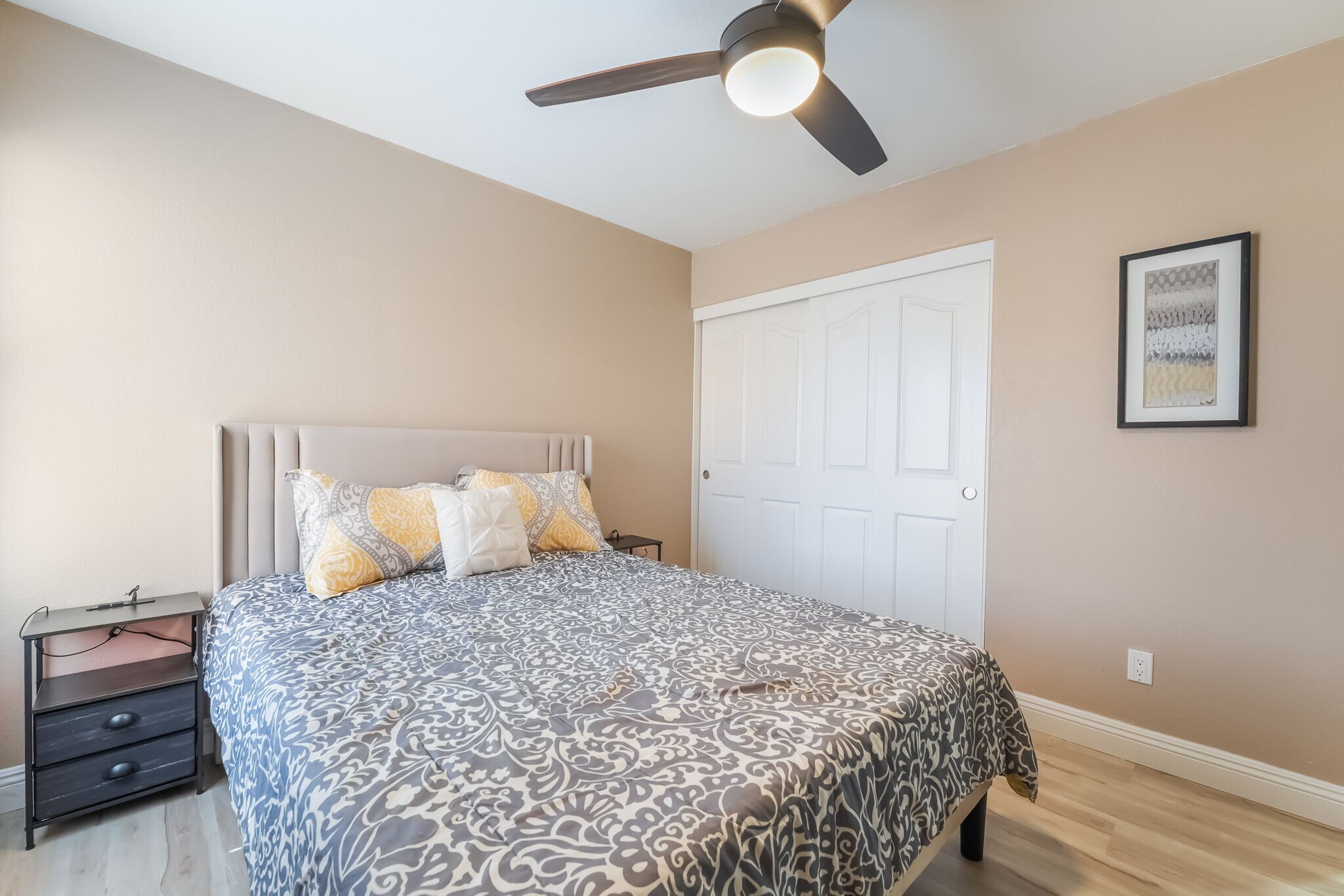 Bedroom featuring light wood finished floors, a closet, and ceiling fan - 1179 Antoinette St