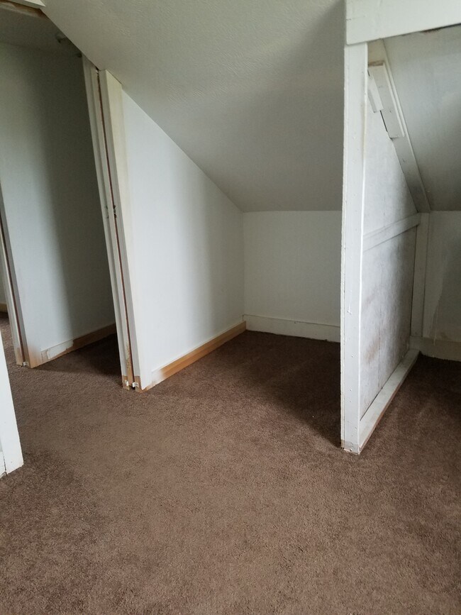 Upstairs Bedroom #2, west wall with entry to top of stairs and entry to Bedroom #1. - 15 Goodrich St