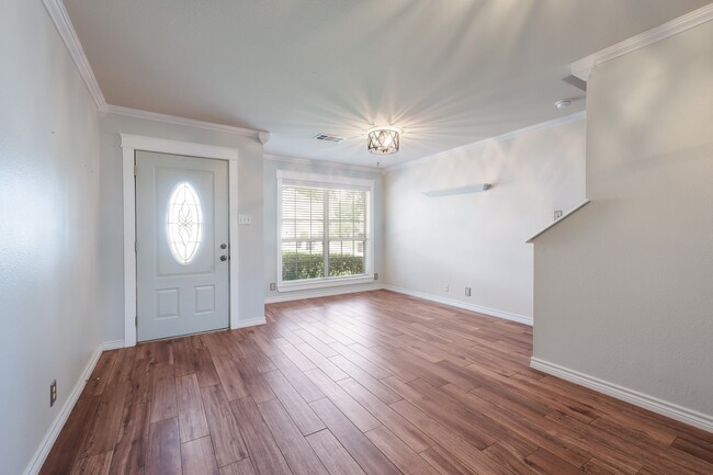 Building Photo - ***APPLICATION CURRENTLY UNDER REVIEW***Modern Elegance: 3-Bedroom Townhome with Wood Flooring, S...