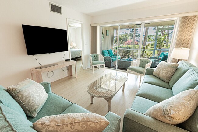 Building Photo - AVAILABLE NOW! Furnished Ground-Floor End Unit | Lake & Pool Views | Minutes to Marco Island & Do...