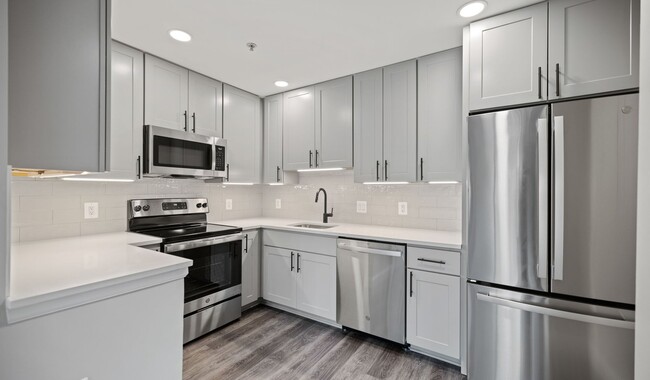 Select homes feature upgraded kitchens with quartz countertops and wood flooring - The Residences at Capital Crescent Trail