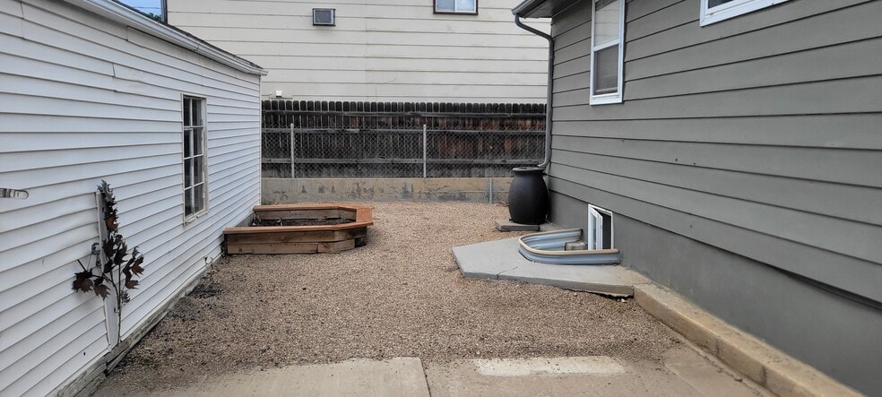 Garage is on left, with a garden box attached. Garage is two-vehicles deep. Another cistern on the b - 814 Atchison Ave