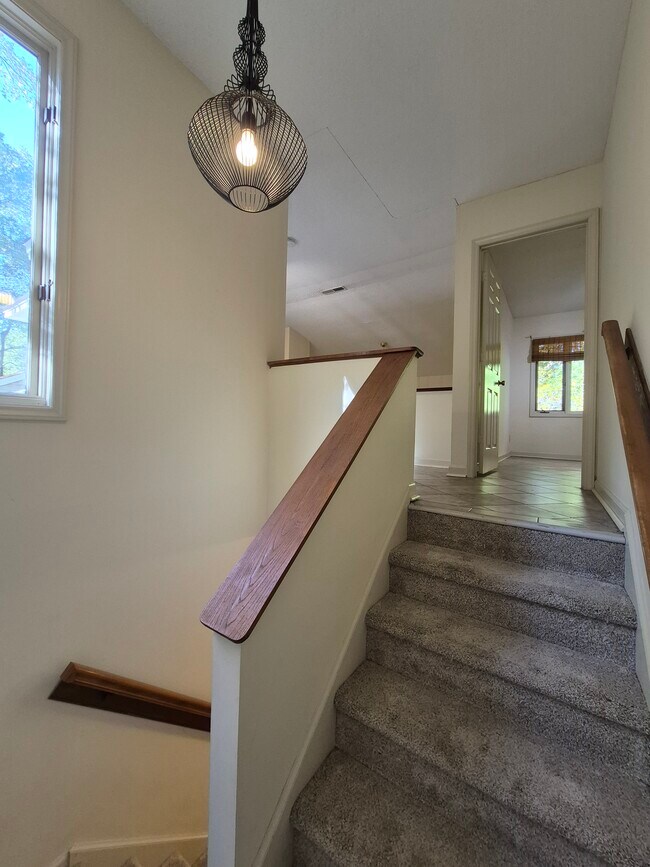 staircase with view of master bedroom - 4422 Beechnut Ln