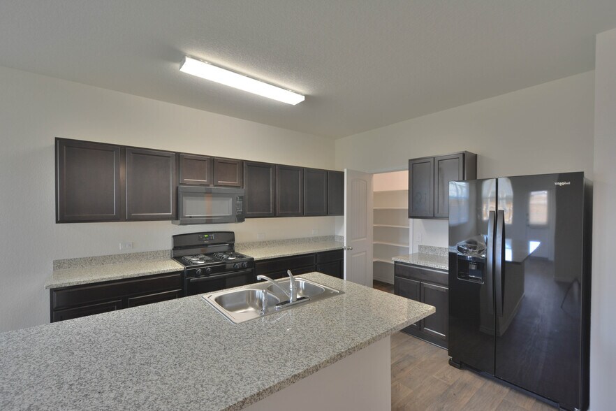 Kitchen with breakfast nook. Gas stove, refrigerator, microwave, dishwasher, and disposal included. *light fixture will be replaced* - 3702 Chappie Lane