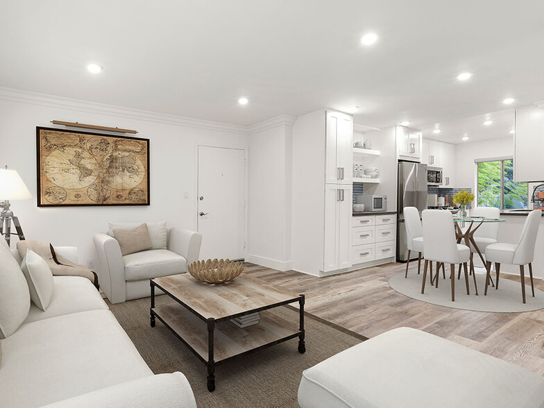 Hardwood floored living room with view of spacious kitchen. - The Glendon Building