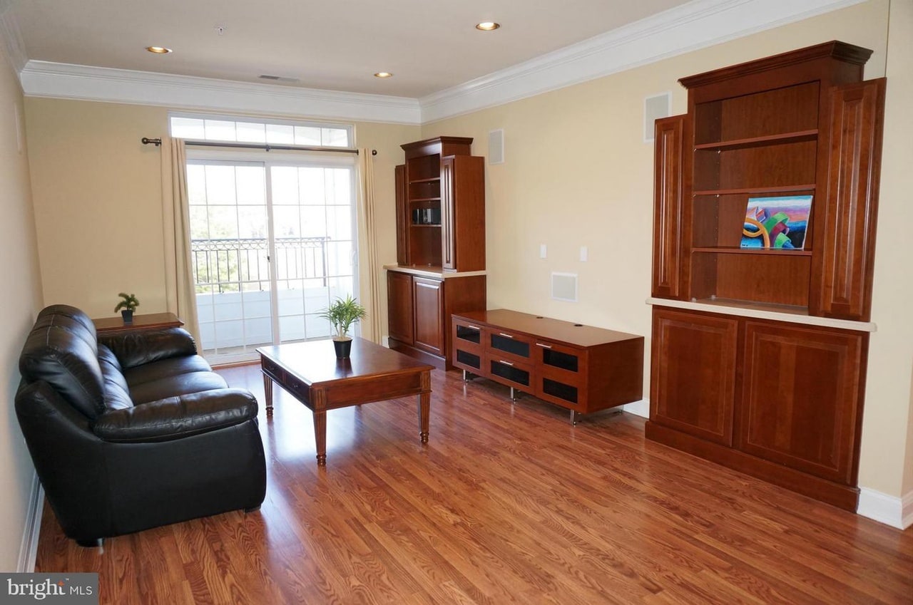 Living room with built in entertainment cabinetries - 5801 Clipper Ln