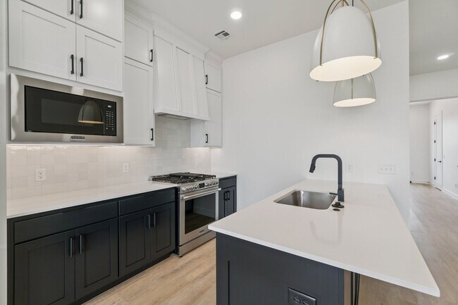 Building Photo - Bright. Clean. Calm. Your Elevated One-Bed...