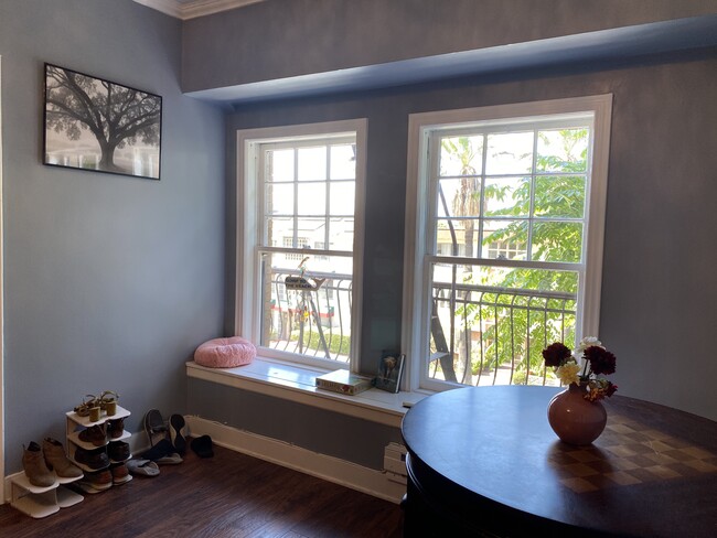 Living room with big windows, smart TV, & and street view - 1030 E Ocean Blvd