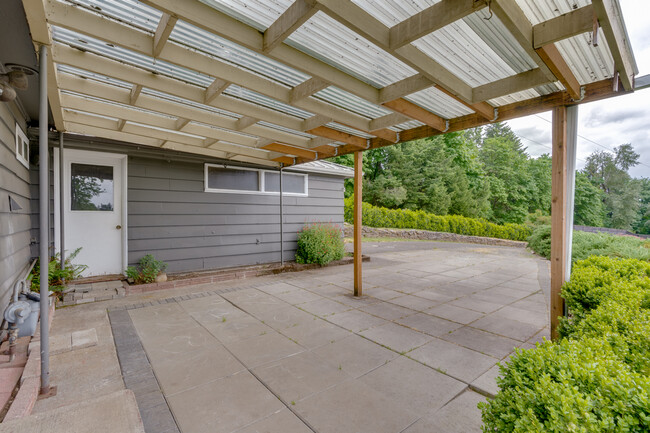 Large covered patio next to the garage is perfect for indoor / outdoor living - 211 Farview Drive