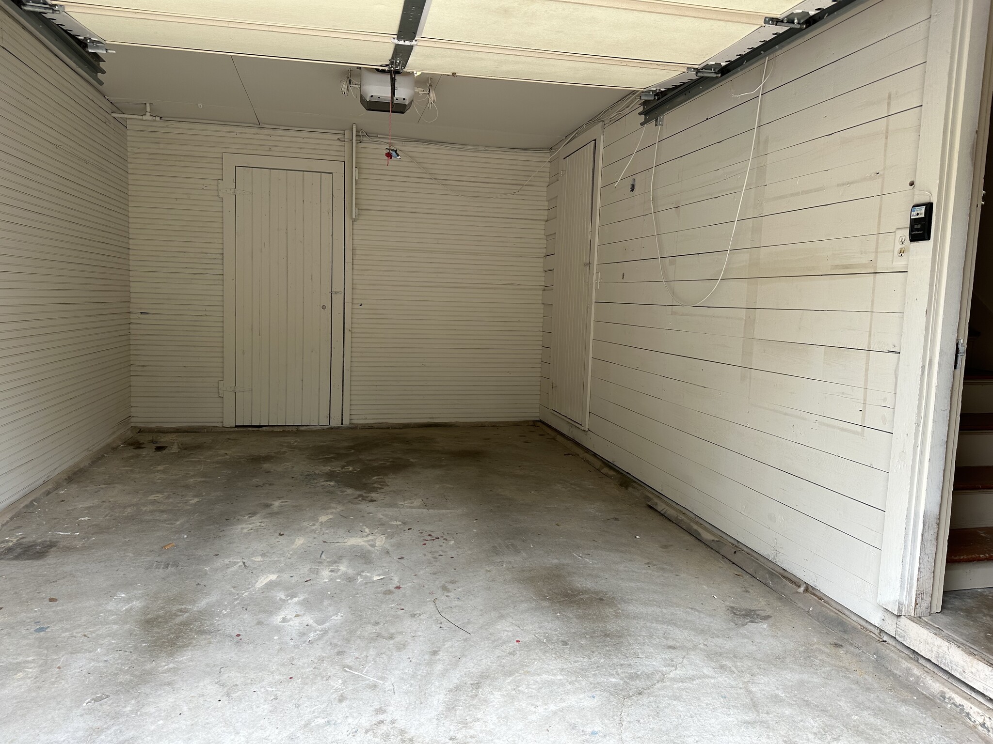 Garage interior with storage closet and auto door opener - 314 E 7th St